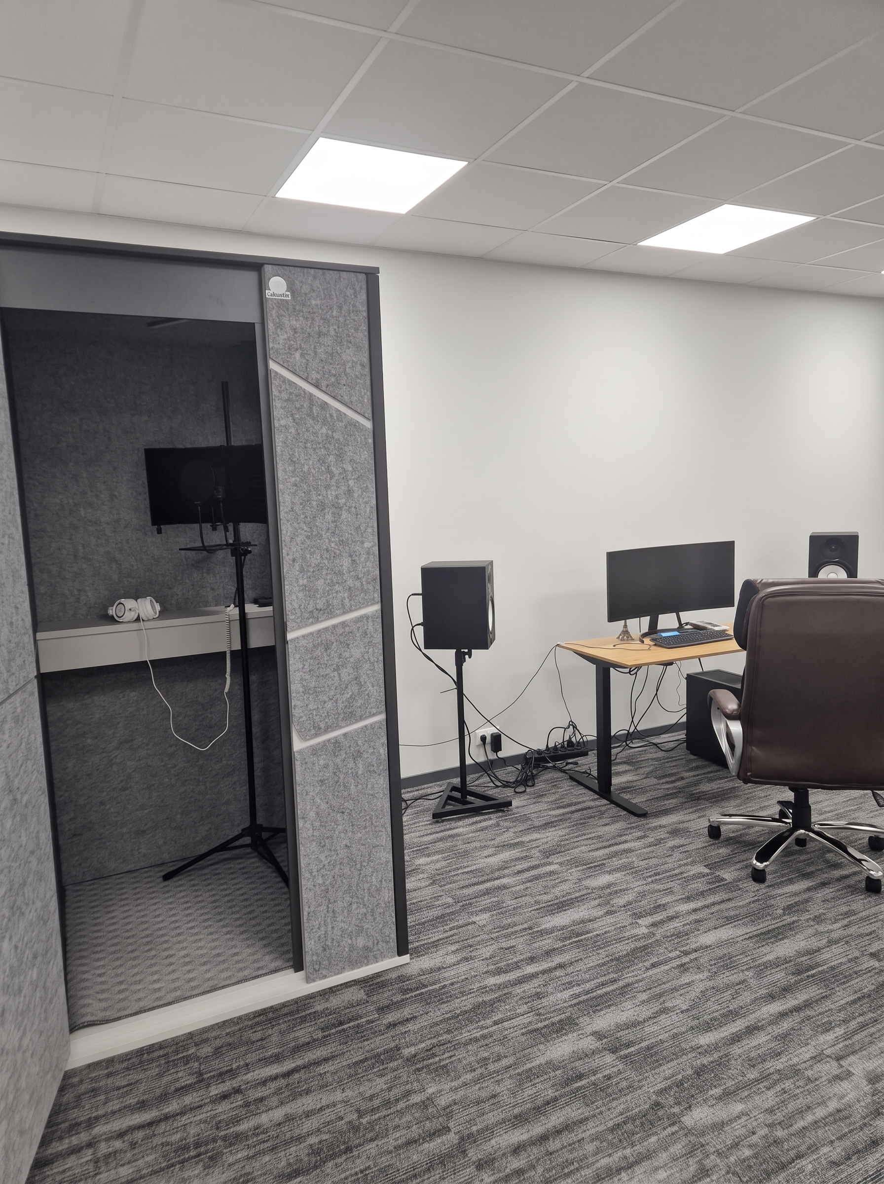 Dedicated vocal booth beside the studio recording workstation