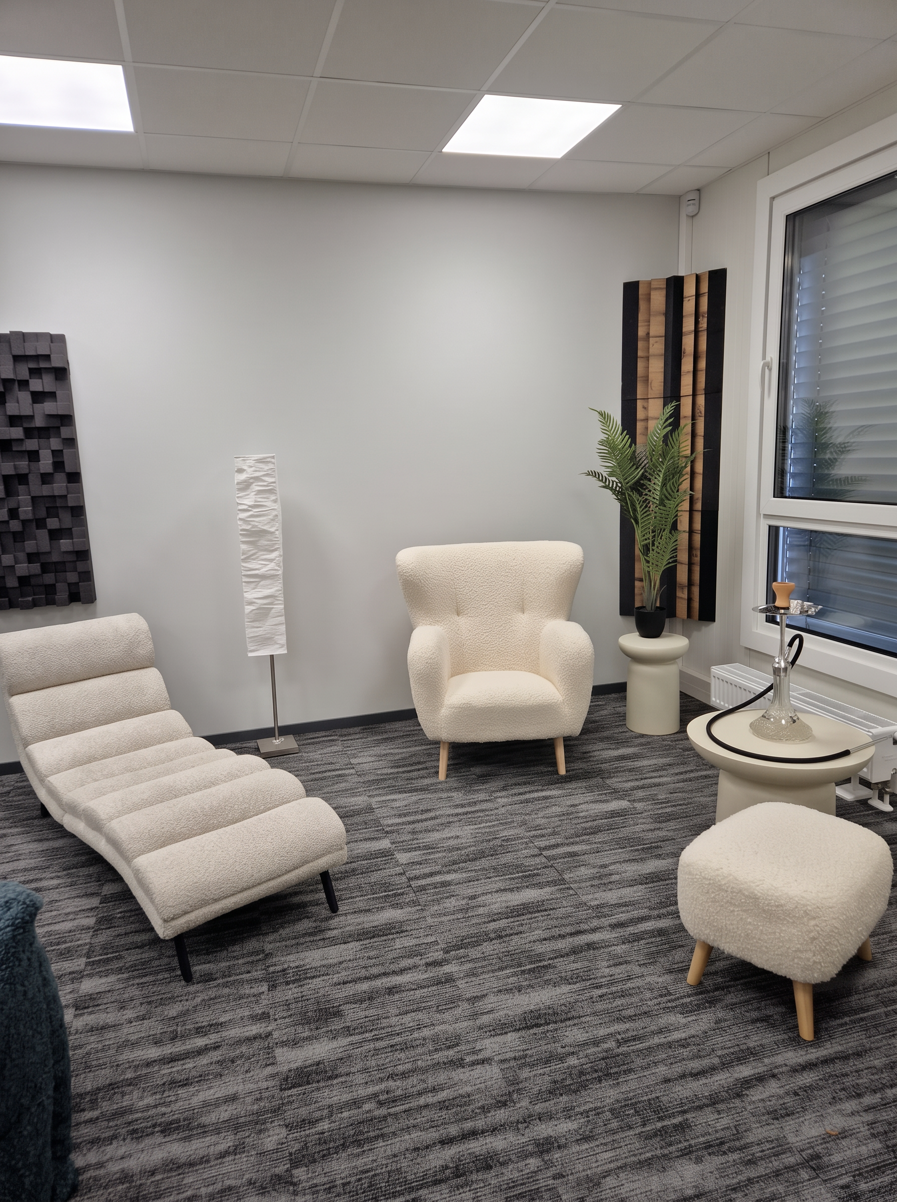 Quiet corner of the studio with a cream chaise and armchair